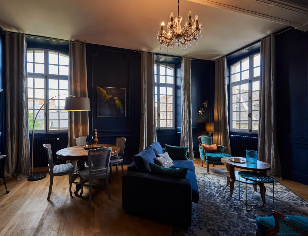 The interior view of a living room showcasing white custom wood windows in a country house.