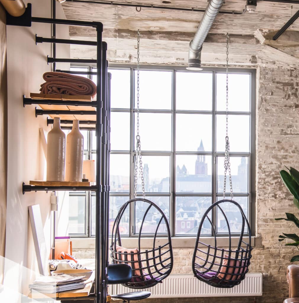 The interior of an apartment showcasing a wall of steel windows.